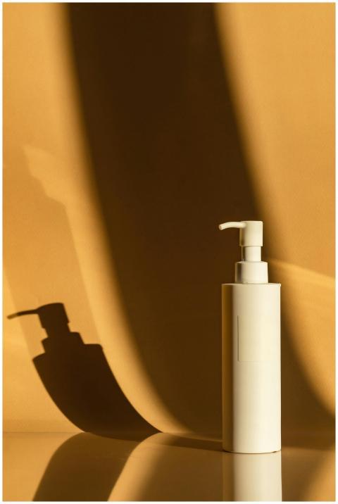 Elegant minimalist image of a beige toiletry bottl