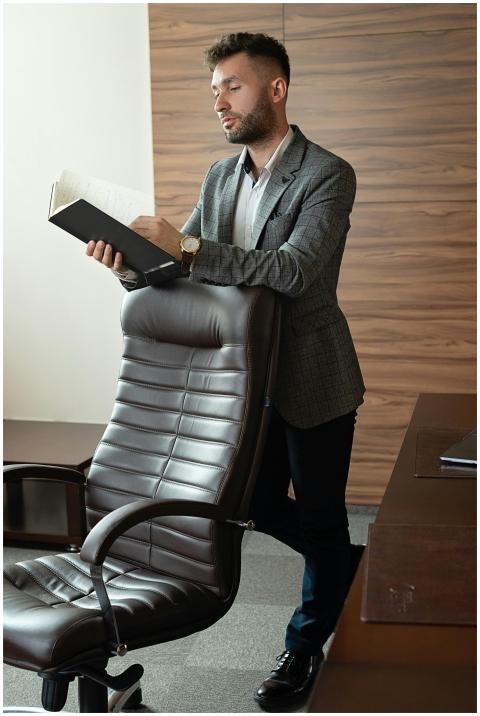 Businessman in a gray blazer looking at documents