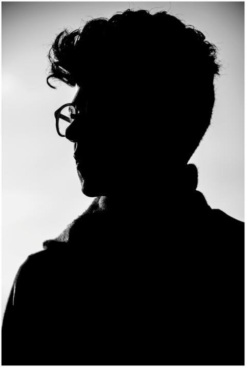 Artistic black and white profile silhouette of a m