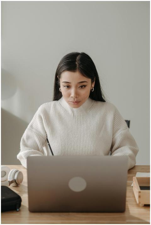 Asian woman in a cozy workspace focused on compute