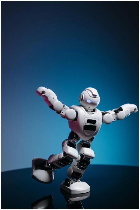 White humanoid toy robot with glowing eyes display