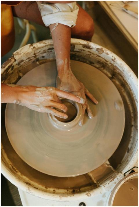 Close-up of hands shaping clay on a potter's wheel