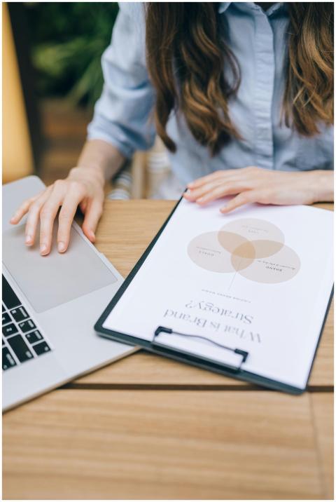 A woman examining a brand strategy document on a c