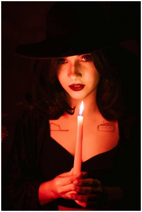 Portrait of a woman dressed as a witch, holding a