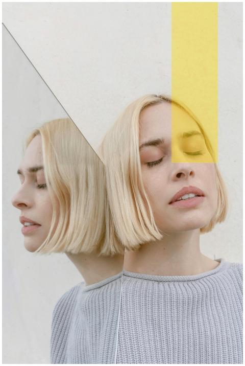 Creative portrait of a woman with a mirror reflect