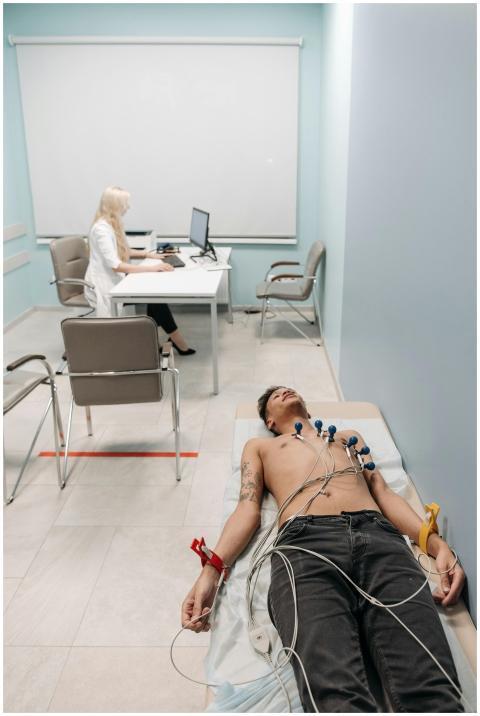 A man undergoing an ECG medical procedure in a cli