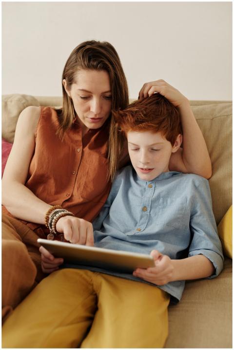 A mother and son bonding as they use a tablet toge