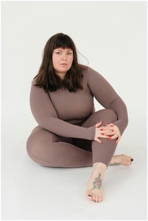 Full body of serious overweight female in sportswe