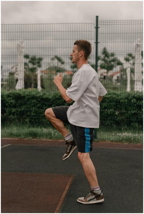 Side view of a young man in sportswear exercising