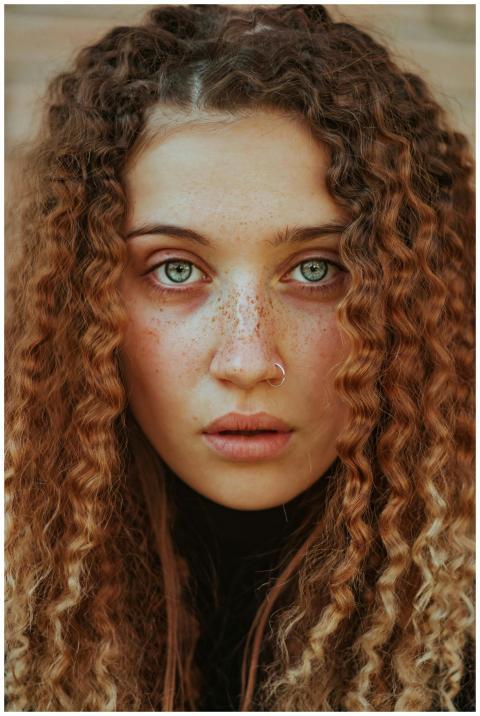 Close-up portrait of a woman with ginger curly hai