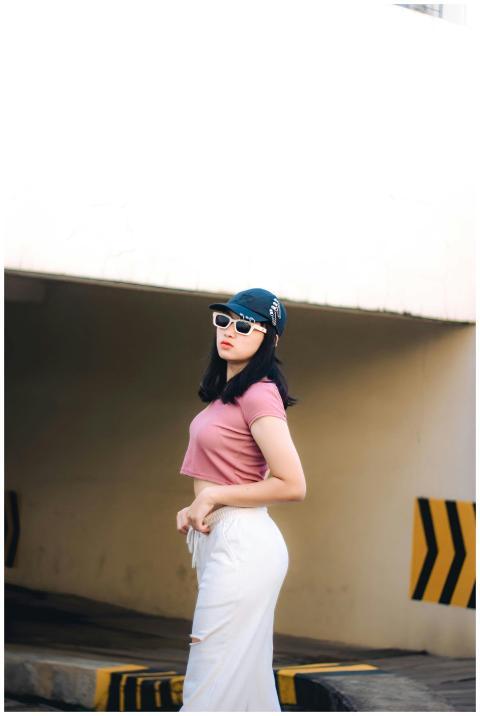 Fashionable woman in stylish outfit posing confide