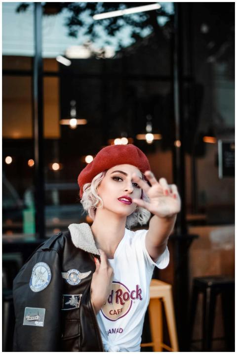Chic woman in a beret posing confidently in a casu