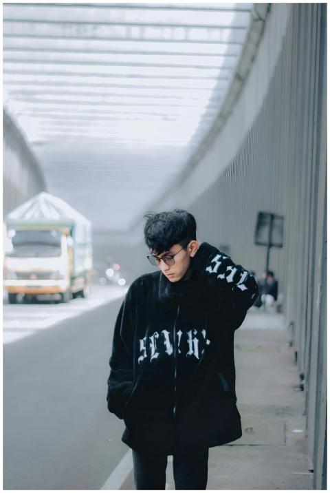 Casual portrait of a young man in modern street st