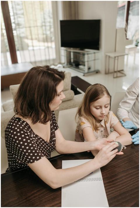 A mother and child in a home consulting with a hea