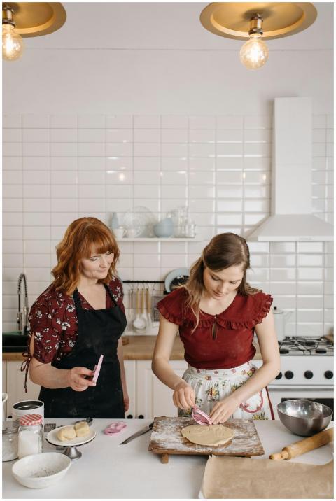A mother and daughter bond while baking in a cozy