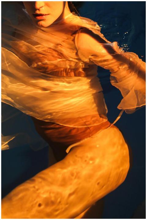 Captivating underwater shot of a person wrapped in
