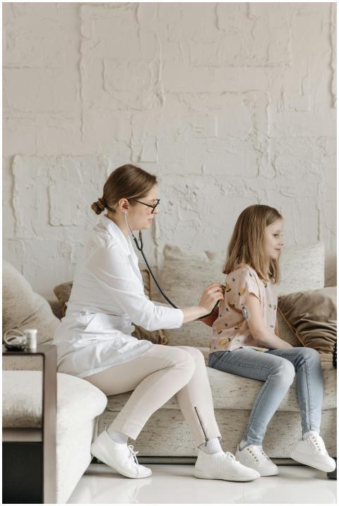 A pediatric doctor checks a girl's health at home,