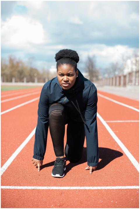 Focused female athlete in activewear getting ready