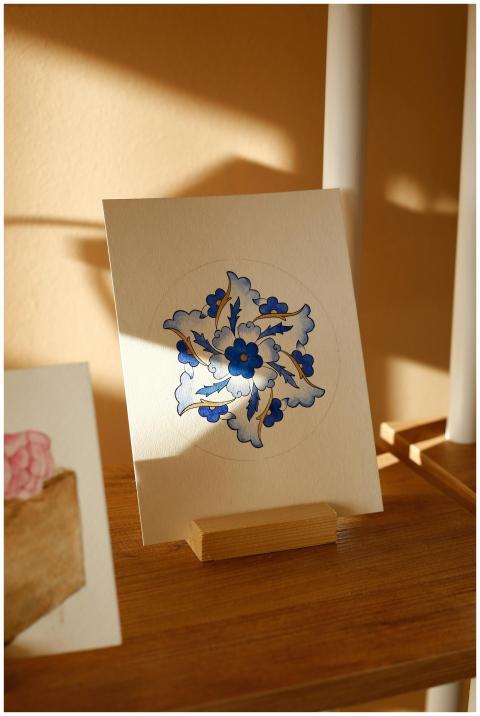 Art print on easel featuring blue floral design in
