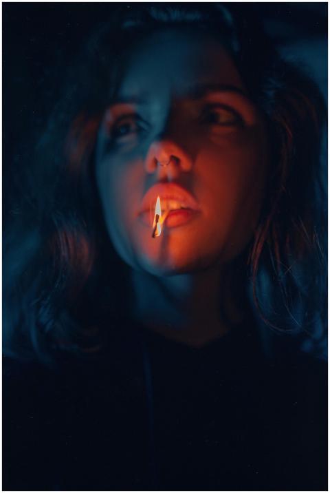 Eerie portrait of a woman illuminated by a matchst