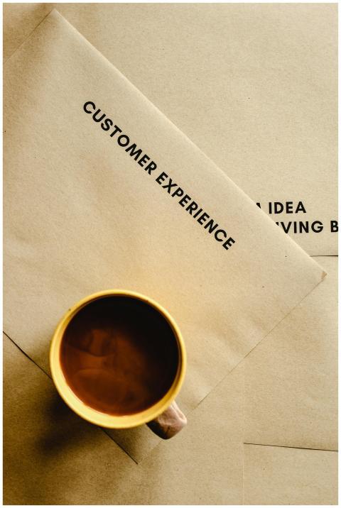 Aesthetic flat lay of a coffee cup on brown envelo