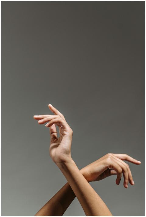 Close-up of graceful hands against a gray backgrou