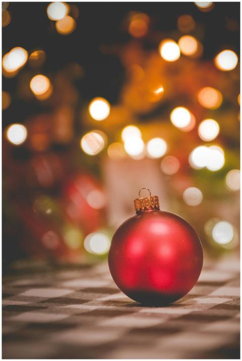 Vibrant red Christmas ornament with bokeh backgrou