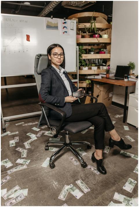 Professional woman in modern office with money on