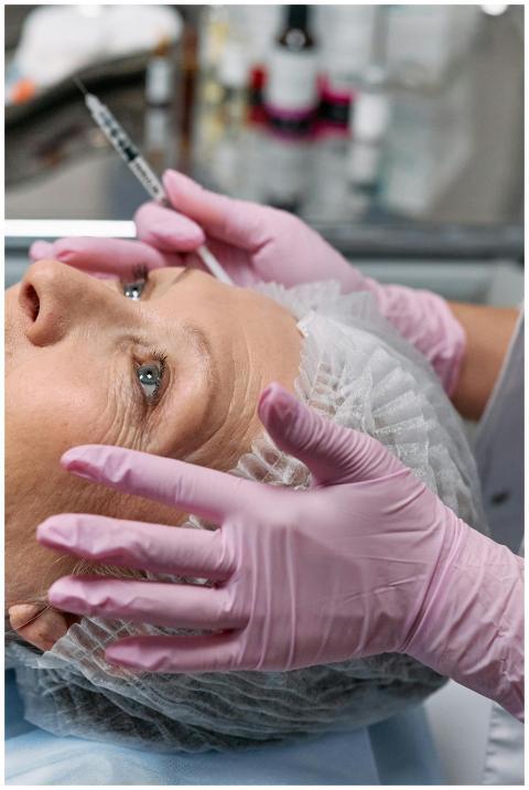 Close-up of a senior woman receiving a cosmetic in