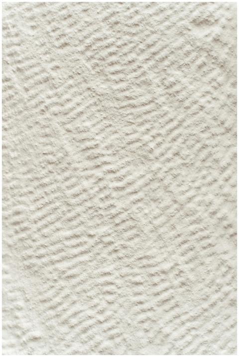 Close-up of a beige linen fabric texture with a wa