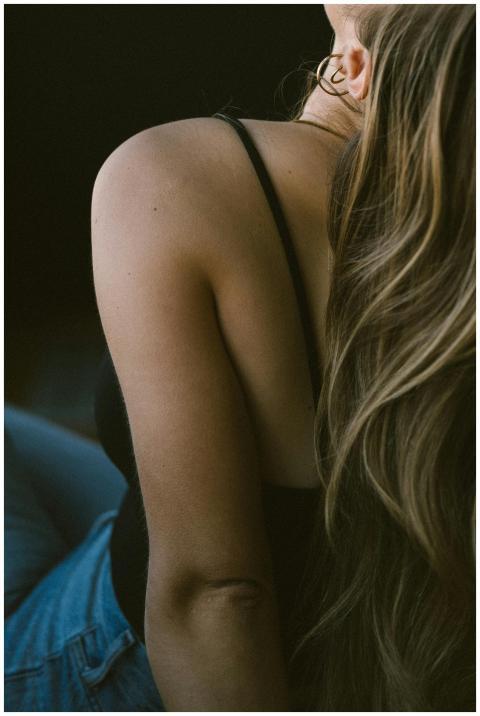 Artistic close-up of a woman's back with long blon