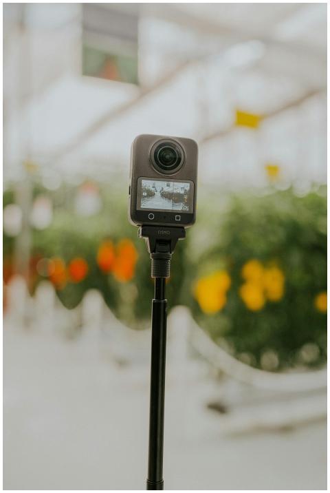 A 360 camera on a tripod capturing a colorful, blu