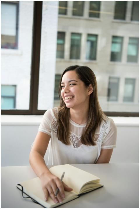 Woman enjoying writing in a notebook with natural