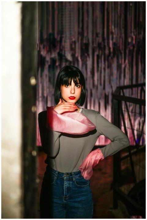 Artistic portrait of a woman posing indoors with s