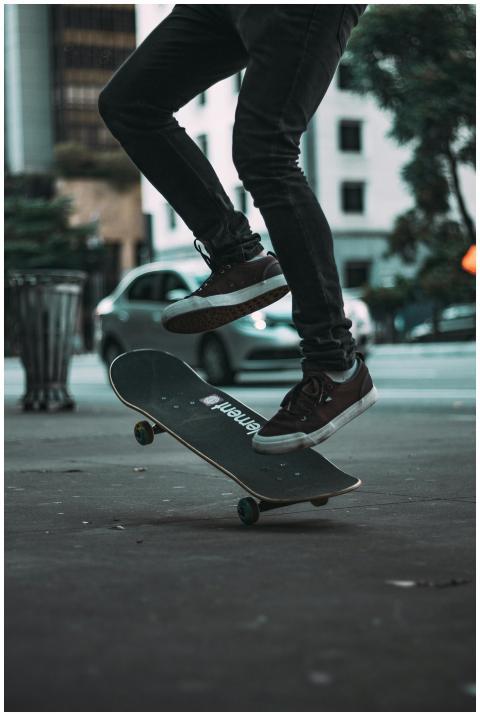 A skateboarder executing a trick on the streets of