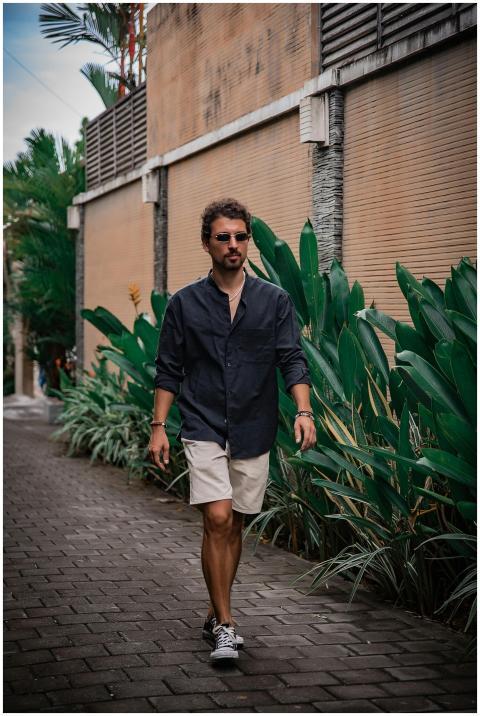 Man walking along a lush tropical street in Bali,