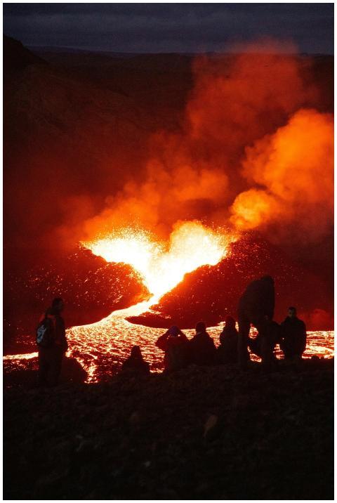 People watching a spectacular volcanic eruption at