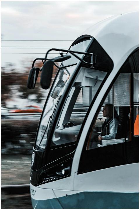 Close-up of a modern tram with a focused driver, c