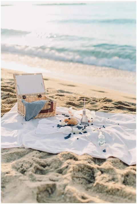 A peaceful beach picnic scene with a basket, blank