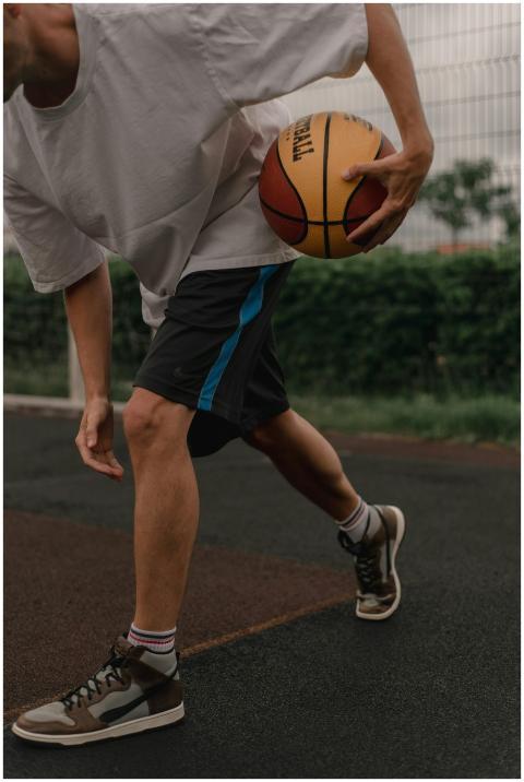 Close-up of a young man practicing basketball drib