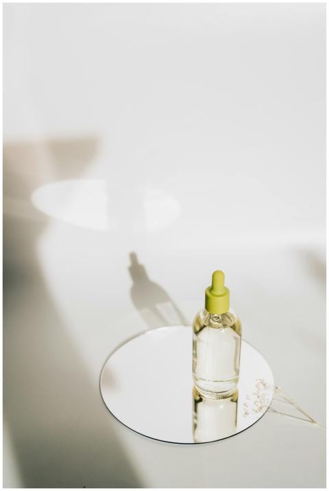 A minimalist close-up of a skincare dropper bottle