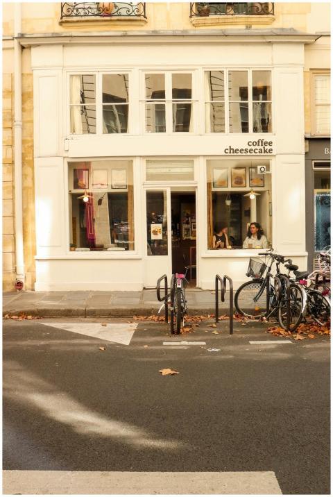 Cozy cafe facade with bicycles and autumn leaves i