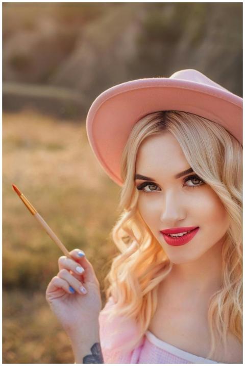 Elegant blonde woman outdoors in Kyiv holding a pa