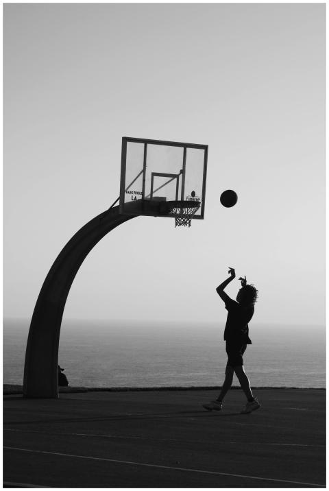 Silhouette of a person shooting a basketball on an