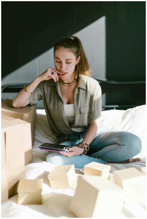 Woman working on her online business with packages