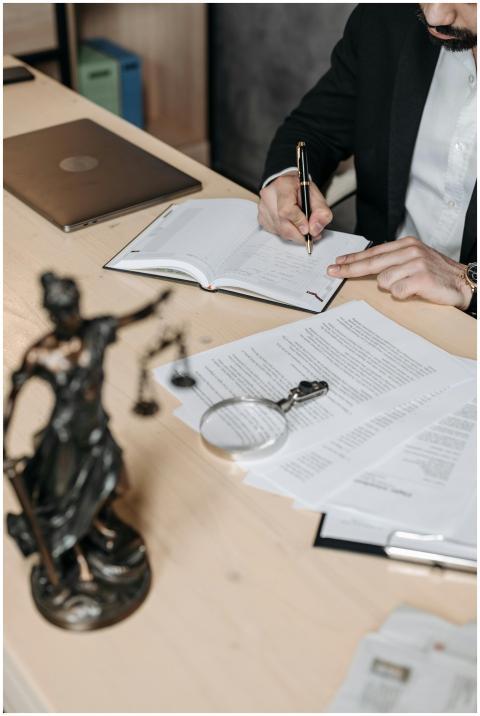 Professional working on documents at desk with leg