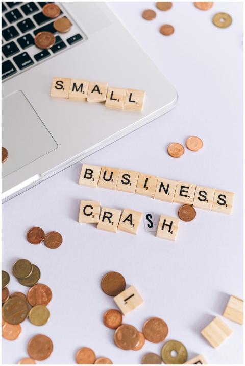 Scrabble tiles spelling 'Small Business Crash' wit