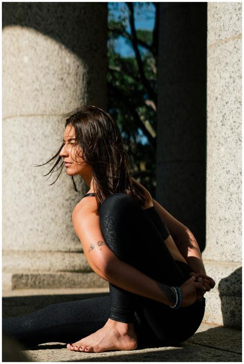Focused woman practicing yoga in natural sunlight,