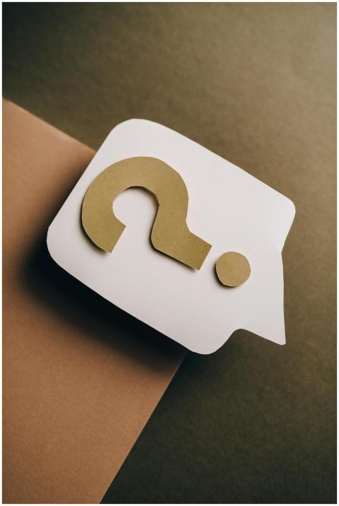 Artistic paper craft of a question mark on neutral