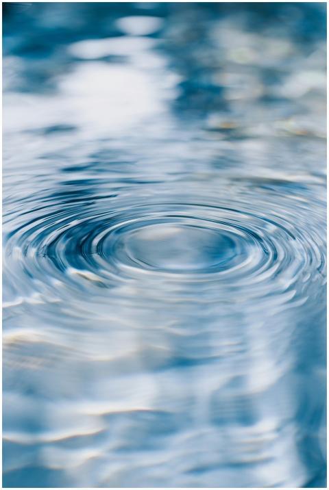 Serene ripples on clear blue water, capturing tran